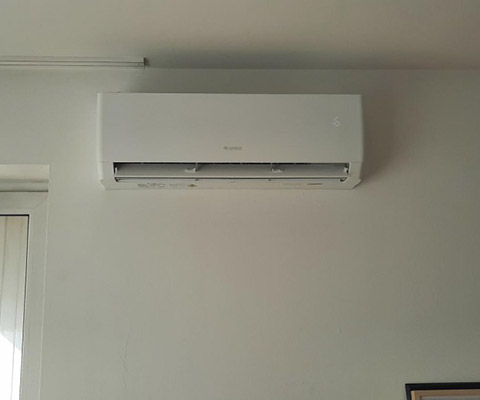 Jednostka wewnętrzna Gree nad oknem z listwą podsufitową — Warszawa