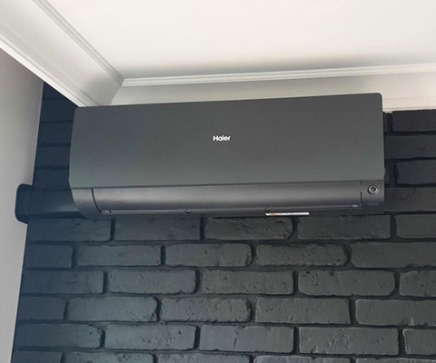 Jednostka wewnętrzna Haier w grafitowej obudowie — Warszawa, salon loft