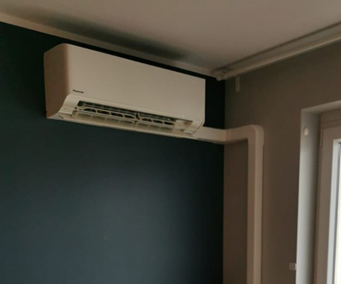 Jednostka wewnętrzna Panasonic zamontowana na ciemnej ścianie we Wrocławiu